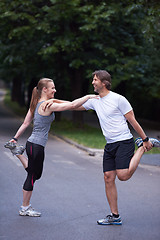 Image showing jogging couple stretching