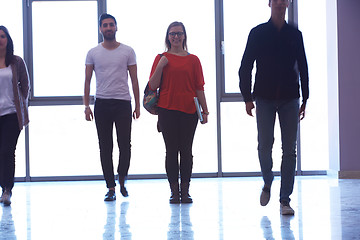 Image showing student girl standing with laptop, people group passing by