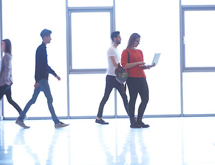 Image showing student girl standing with laptop, people group passing by