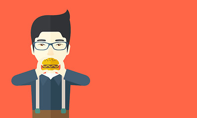 Image showing Man eating hamburger. 