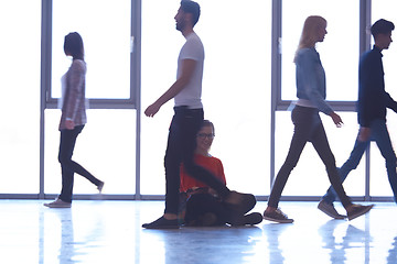 Image showing student girl standing with laptop, people group passing by