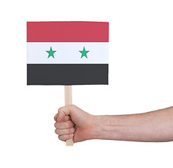 Image showing Hand holding small card - Flag of Syria