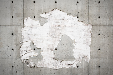 Image showing Old billboard and a grey wall with torn poster