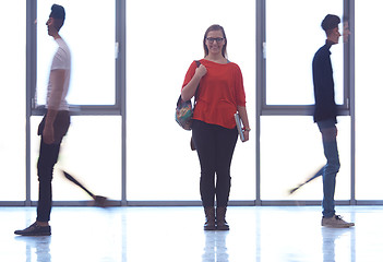 Image showing student girl standing with laptop, people group passing by