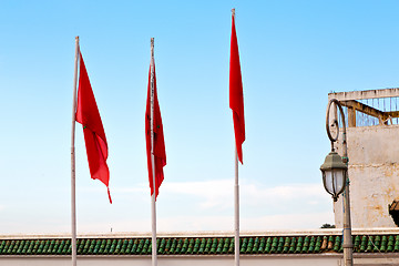 Image showing tunisia  waving   in the blue sky   and battlements  wave