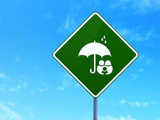 Image showing Protection concept: Family And Umbrella on road sign background