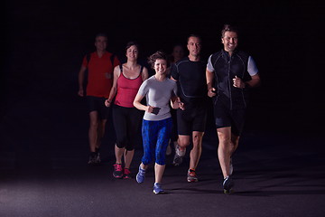 Image showing people group jogging at night