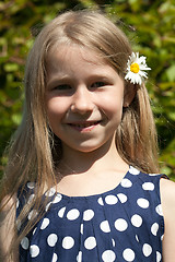 Image showing young girl with camomile flower in the hair