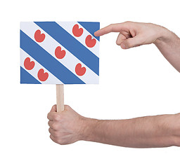 Image showing Hand holding small card - Flag of Friesland