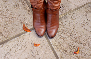 Image showing Toes of tan leather boots on a concrete 