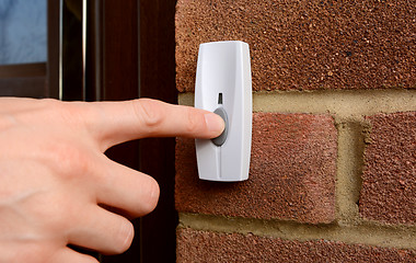 Image showing Close-up of woman pressing a doorbell