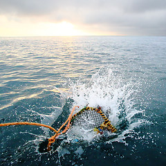 Image showing Splashing creel in the sea at dawn