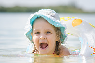 Image showing Four-year girl with an open mouth with happiness bathed in the river