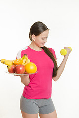 Image showing Athlete swings his left hand holding a plate of fruit in his right hand