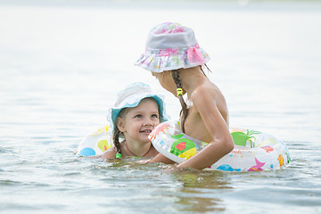 Image showing Two girls are swimming in the river