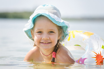 Image showing Happy four-year girl bathes in the river