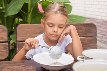 Image showing Six year old girl puts his plate buckwheat