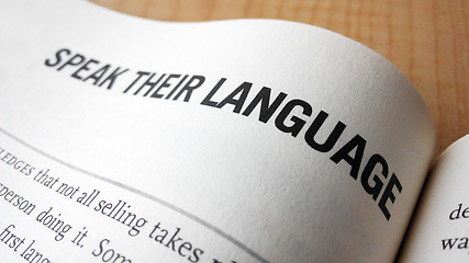 Image showing Speak their language word on a book