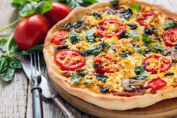 Image showing Pizza with tomatoes and cheese close up.