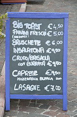 Image showing Menu of a restaurant on the beach where there is' wrote: 