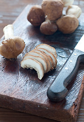 Image showing 
Raw mushrooms on a wooden cutting board ready to be sliced