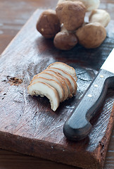 Image showing 
Raw mushrooms on a wooden cutting board ready to be sliced