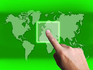 Image showing Hand Touch Touchscreen On World Map Shows Internet Web