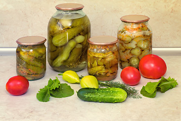 Image showing Canned cucumbers with spices in glass jars.