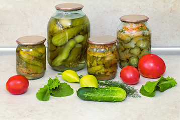 Image showing Canned cucumbers with spices in glass jars.