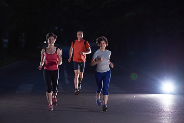 Image showing people group jogging at night