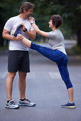 Image showing jogging couple stretching