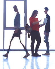 Image showing student girl standing with laptop, people group passing by