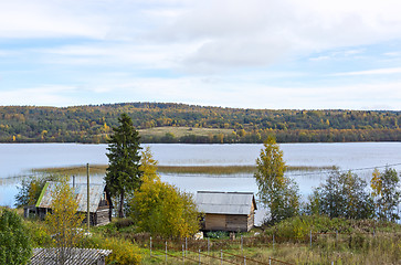 Image showing Rural houses on lakeside in taiga