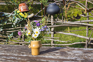 Image showing Bouquet of flowers in vase on rustic table