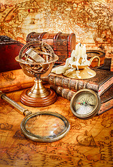 Image showing Vintage magnifying glass lies on an ancient world map