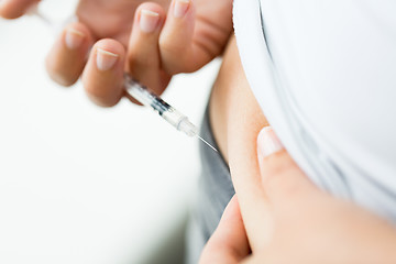 Image showing woman with syringe making insulin injection
