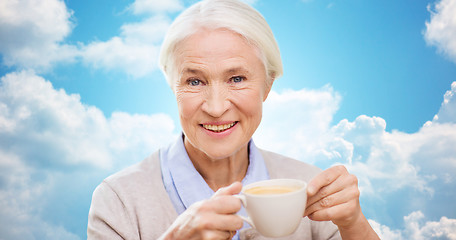 Image showing happy senior woman with cup of coffee