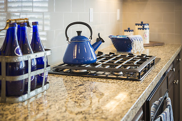 Image showing Marble Kitchen Counter and Stove With Cobalt Blue Decor