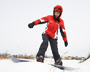 Image showing young adult female snowboarder