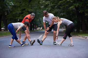 Image showing jogging people group stretching