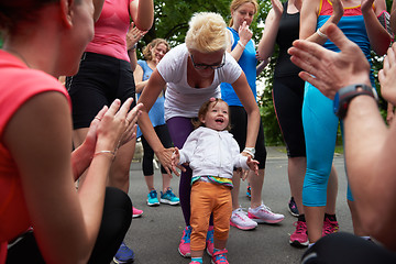 Image showing jogging people group have fun with baby girl