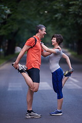 Image showing jogging couple stretching