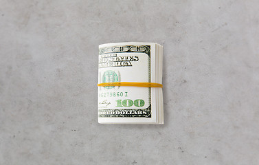 Image showing close uop of dollar money packet tied with rubber