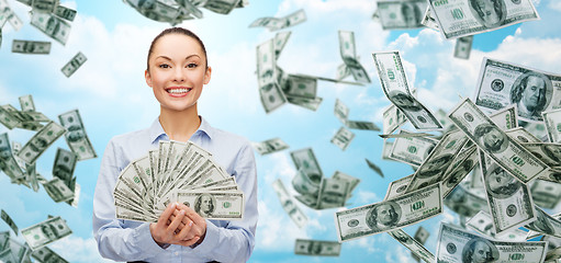 Image showing smiling businesswoman with dollar cash money