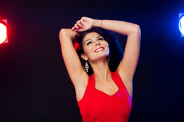 Image showing beautiful sexy woman in red dancing at nightclub