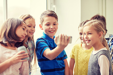 Image showing group of school kids with smartphone and soda cans