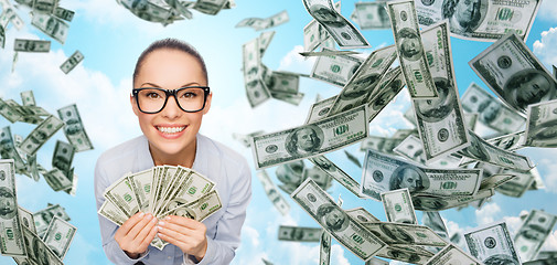 Image showing smiling businesswoman with dollar cash money