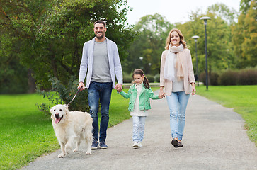 Image showing happy family with labrador retriever dog in park