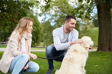 Image showing happy couple with labrador dog walking in city