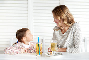 Image showing happy family having dinner at restaurant or cafe